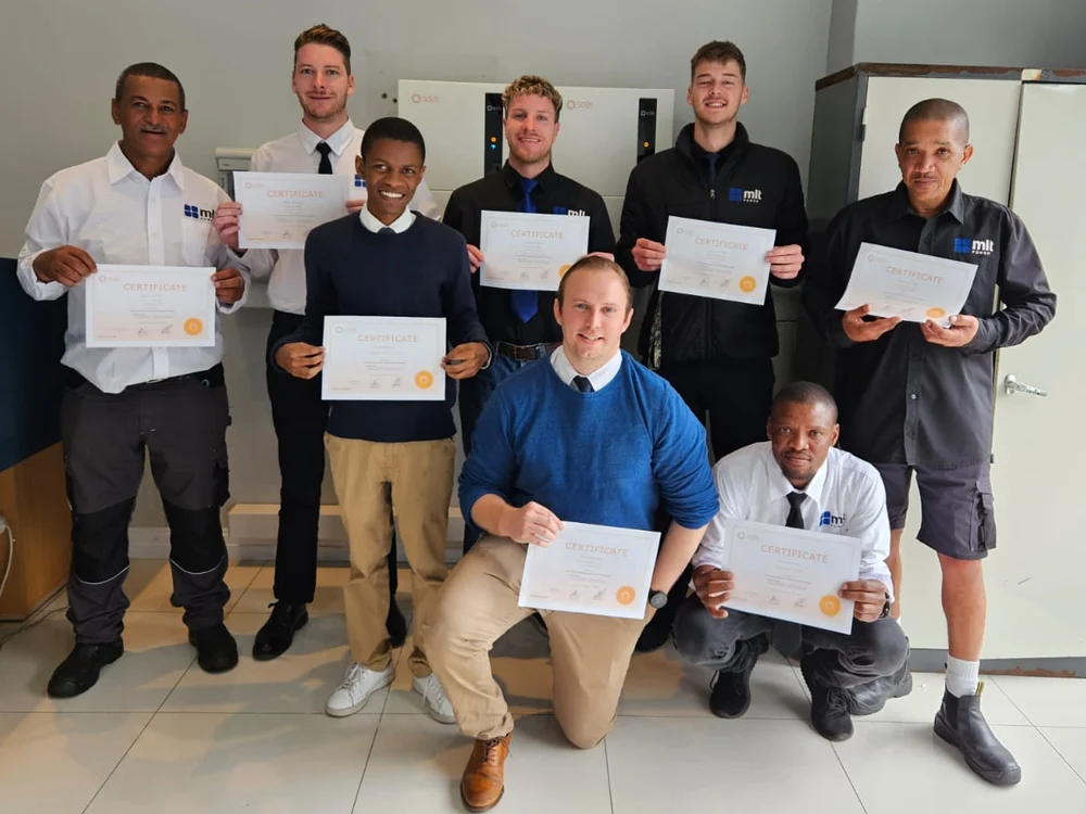 MLT Power installation team with their training certificates